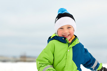 Image showing happy little boy in winter clothes outdoors