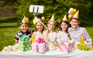 Image showing happy kids taking selfie on birthday party