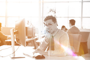 Image showing Young businessman using computer at work