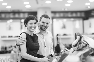 Image showing couple chooses shoes At Shoe Store