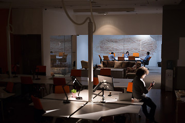 Image showing man working on computer in dark office