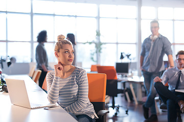 Image showing businesswoman using a laptop in startup office