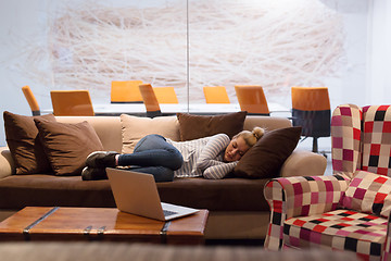 Image showing woman sleeping on a sofa  in a creative office