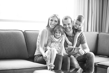 Image showing happy young couple spending time with kids