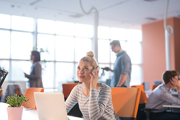 Image showing businesswoman using a laptop in startup office