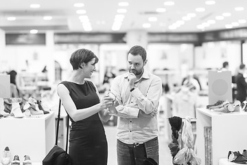 Image showing couple chooses shoes At Shoe Store