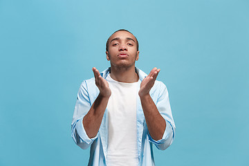 Image showing Portrait of attractive man with kiss isolated over blue background