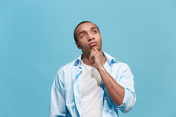 Image showing Young serious thoughtful businessman. Doubt concept.