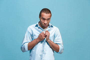 Image showing Afro man looking suprised and bewildered isolated on blue