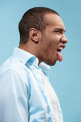 Image showing Crazy Afro-American man is looking funny against blue background