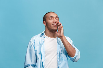 Image showing Isolated on pink young casual man shouting at studio