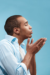 Image showing Portrait of attractive man with kiss isolated over blue background