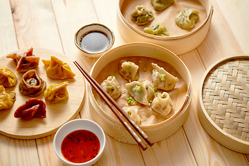 Image showing Traditional chinese dumplings served in the wooden bamboo steamer