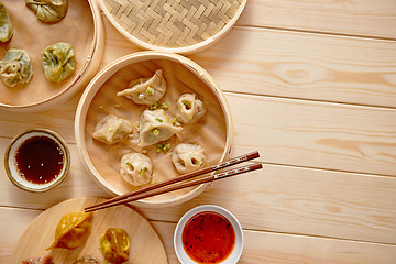 Image showing Traditional chinese dumplings served in the wooden bamboo steamer