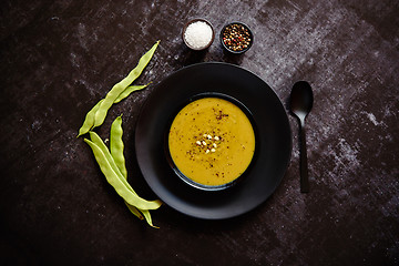 Image showing Creamy soup with green pea in a ceramic white plate