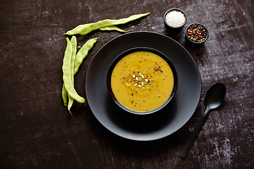 Image showing Creamy soup with green pea in a ceramic white plate