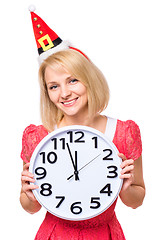 Image showing Woman in santa hat with clock