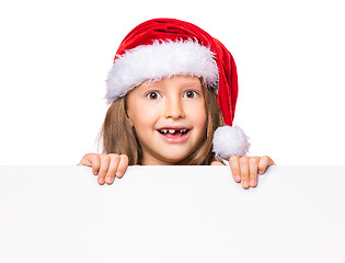 Image showing Girl in santa hat with blank