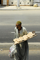 Image showing poor old man sells wheat flat cakes