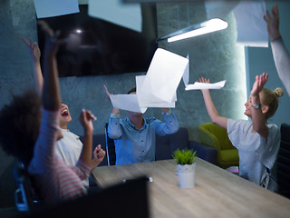 Image showing multiethnic Group of young business people throwing documents