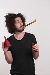 Image showing Portrait of a man in party hat blowing in whistle