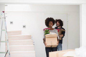 Image showing multiethnic couple moving into a new home