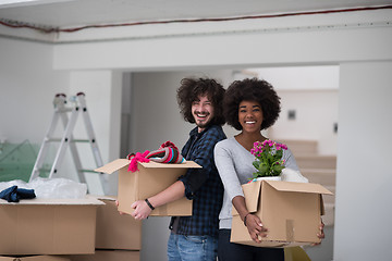 Image showing multiethnic couple moving into a new home