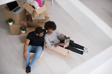 Image showing African American couple  playing with packing material