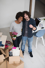 Image showing multiethnic couple moving into a new home