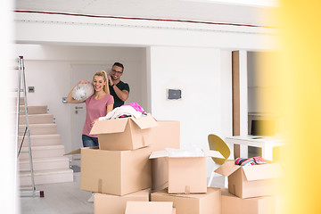 Image showing couple carrying a carpet moving in to new home