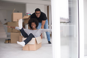 Image showing African American couple  playing with packing material