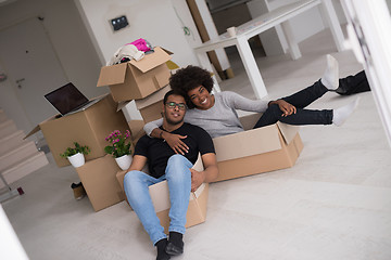 Image showing African American couple  playing with packing material