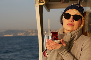 Image showing Young woman drinking traditional Turkish tea