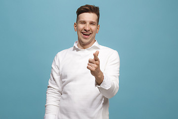 Image showing The happy business man point you and want you, half length closeup portrait on blue background.