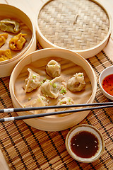 Image showing Oriental traditional chinese dumplings served in the wooden steamer