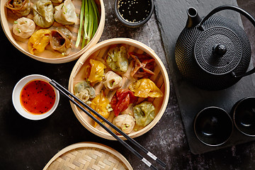 Image showing Oriental traditional chinese dumplings served in the wooden steamer