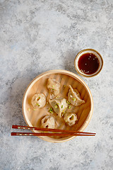 Image showing Delicious chinese dumplings served in wooden bamboo steamer