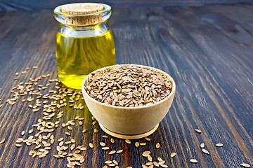 Image showing Flaxen brown seed in bowl with oil on board