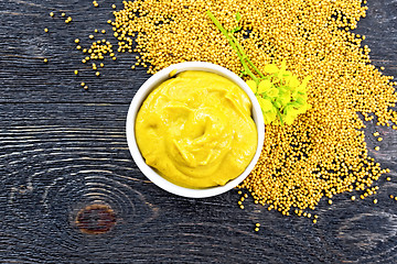 Image showing Sauce mustard in bowl with flower on board top