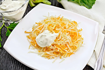 Image showing Salad of carrot and kohlrabi with sour cream on black board