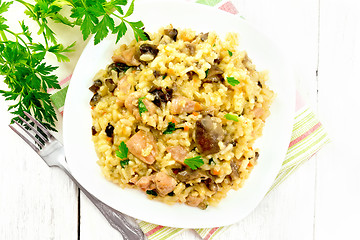 Image showing Risotto with mushrooms and chicken on board top