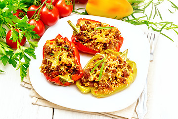 Image showing Pepper stuffed with meat and couscous in plate on light board