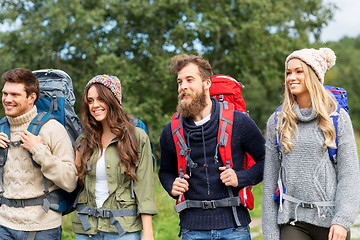 Image showing friends or travelers with backpacks hiking