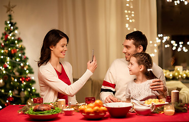 Image showing happy family taking picture at christmas dinner