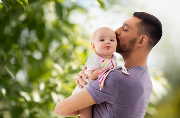 Image showing father kissing little baby daughter