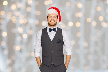 Image showing happy man in santa hat and suit at christmas