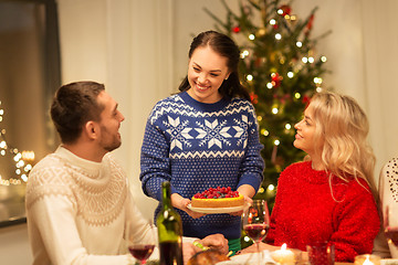 Image showing happy friends having christmas dinner at home