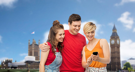 Image showing friends with smartphone over houses of parliament