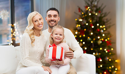 Image showing happy family at home with christmas gift