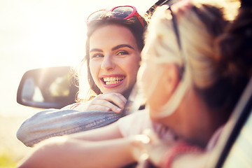 Image showing happy teenage girls or women in car at seaside